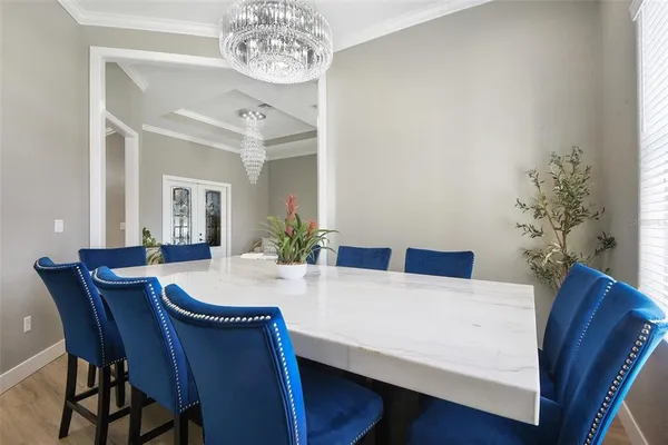 a view of a dining room with furniture and chandelier