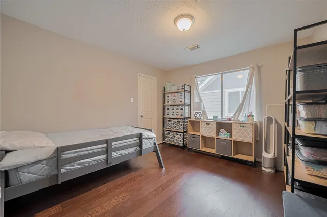a view of bedroom with furniture and wooden floor