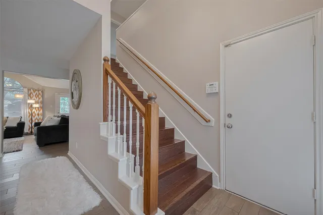 a view of entryway and hall with wooden floor