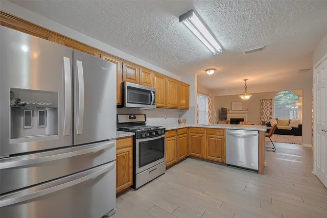 a kitchen with a sink cabinets and stainless steel appliances