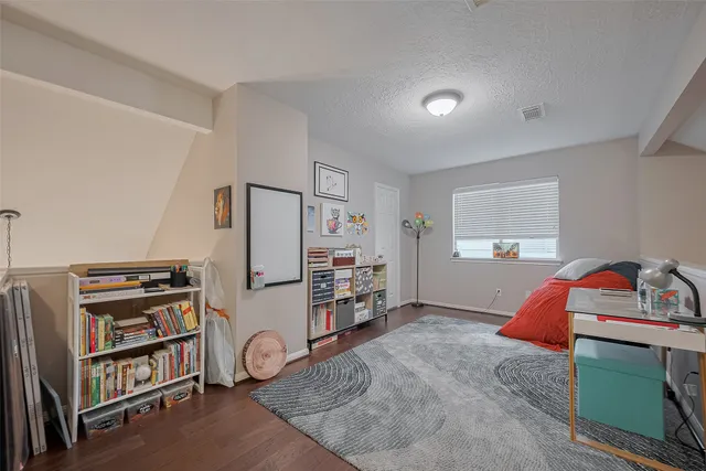 a bedroom with furniture and a book shelf
