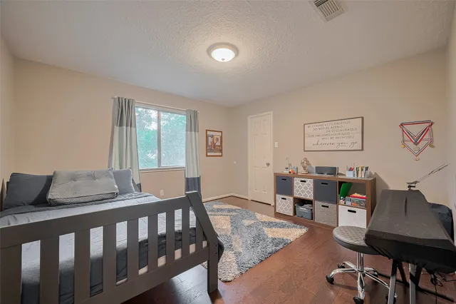 a bedroom with furniture and a wooden floor