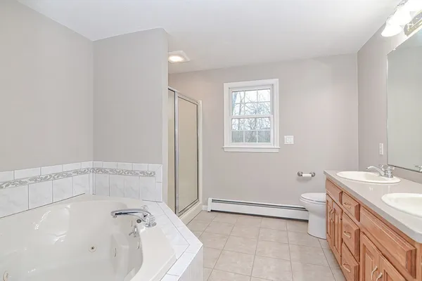 a bathroom with a tub sink and a mirror