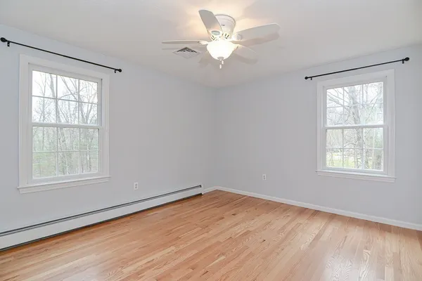 wooden floor in an empty room with a window