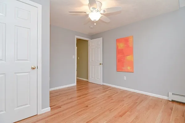 an empty room with wooden floor and a window