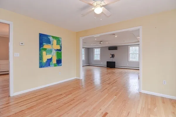 a view of empty room with wooden floor