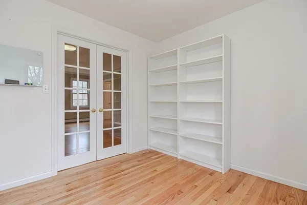 a view of wooden floor and windows in a room