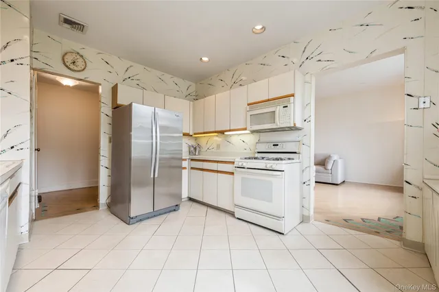 a kitchen with stainless steel appliances a refrigerator sink and cabinets