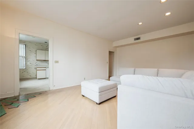 a living room with a couch and next to a window