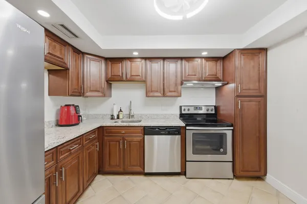 a kitchen with a sink stove and cabinets