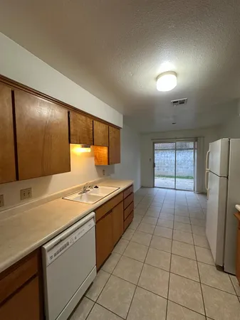 a kitchen that has a sink and a stove