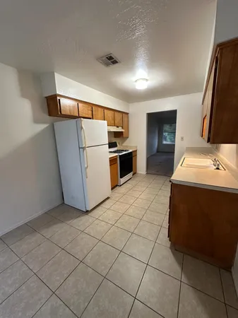 a kitchen with stainless steel appliances a refrigerator and a stove