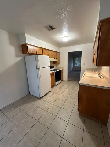 a kitchen with stainless steel appliances a refrigerator and a stove