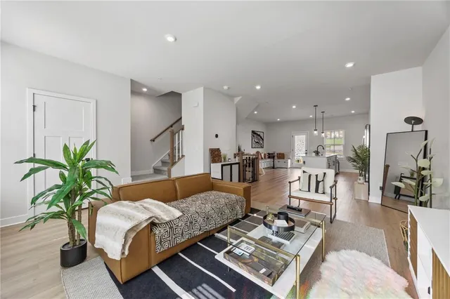 a living room with furniture and wooden floor