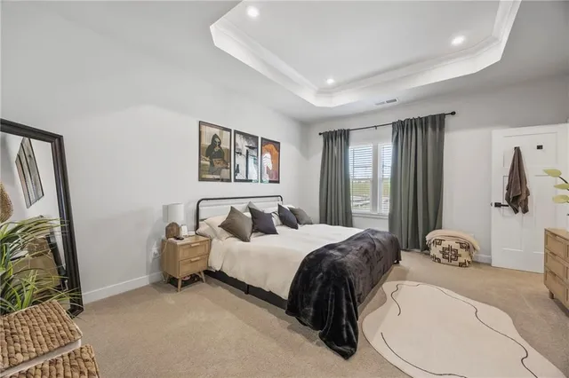 a spacious bedroom with a bed and a window