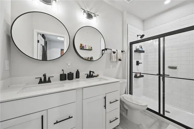 a bathroom with a toilet a sink and a mirror