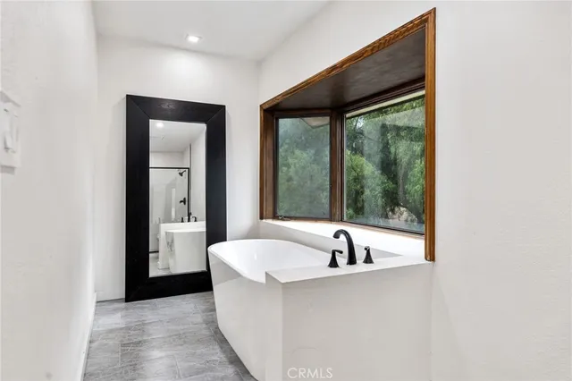 a bedroom with a large bed and a large window