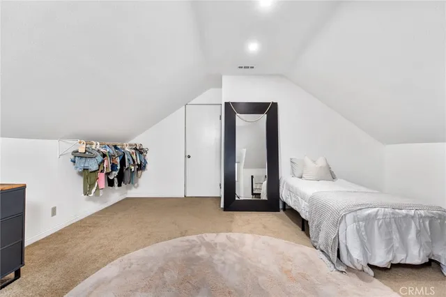 a bedroom with furniture and a large window