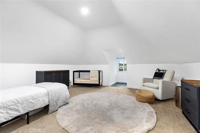 a spacious bedroom with a bed and a window