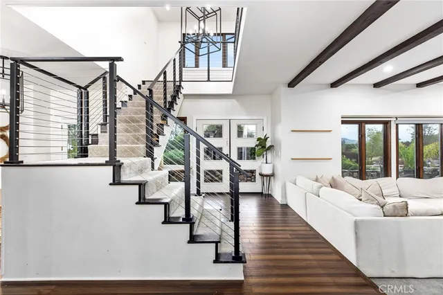 a living room with fireplace furniture and a large window