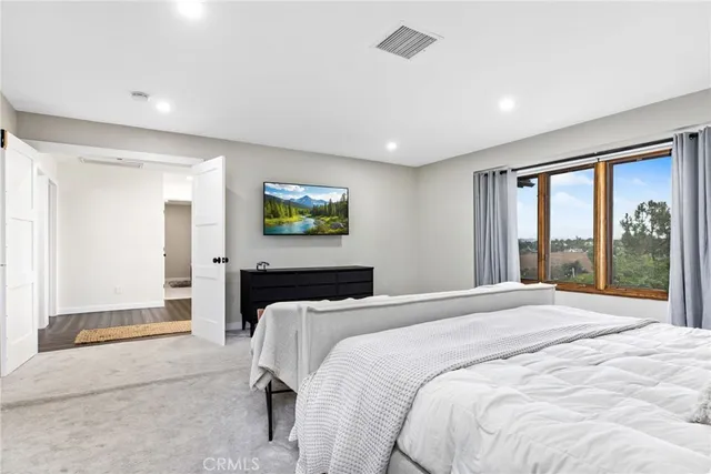 a bedroom with two beds and a chair