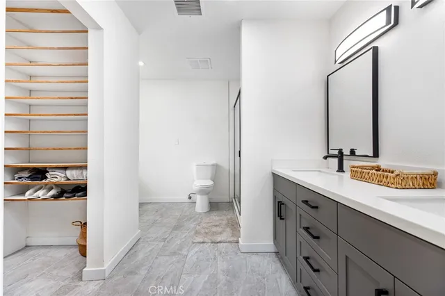 a living room with furniture a flat screen tv and a potted plant