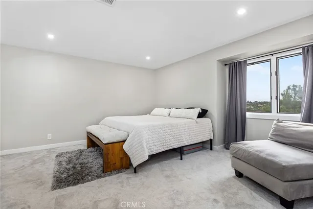 a bathroom with a granite countertop sink toilet and a mirror
