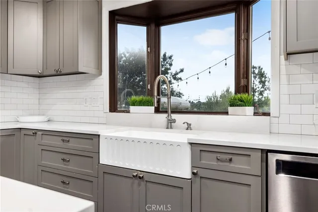 a kitchen with a sink and cabinets