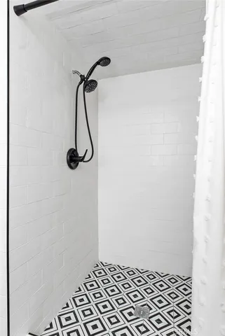 a kitchen with granite countertop a refrigerator stove and wooden floor