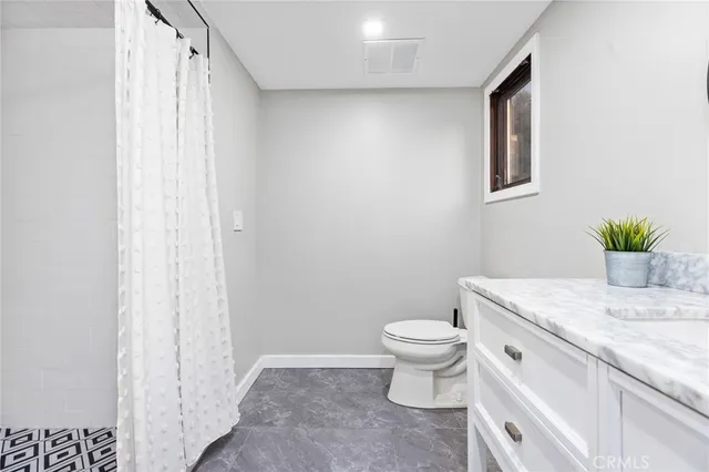 a living room with wooden floor pool table and chairs
