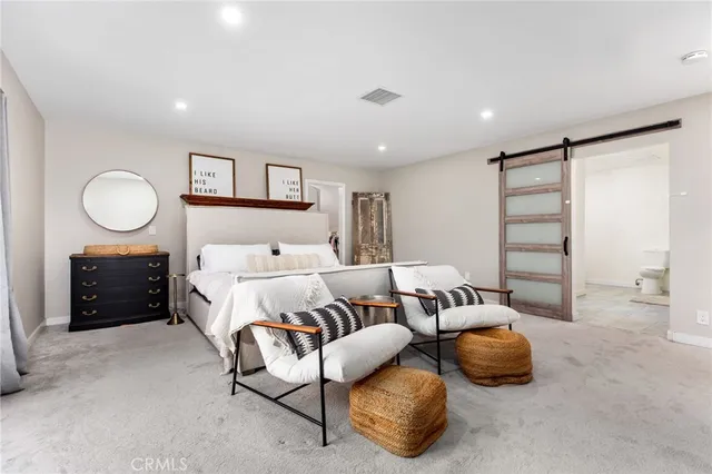 a spacious bedroom with a bed and furniture