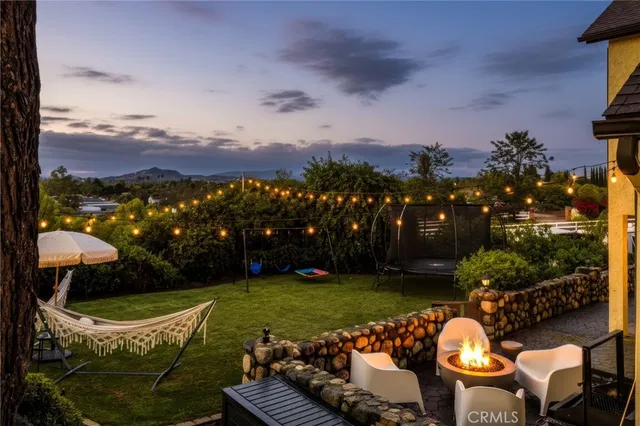 a view of a swimming pool with lawn chairs and a potted plant