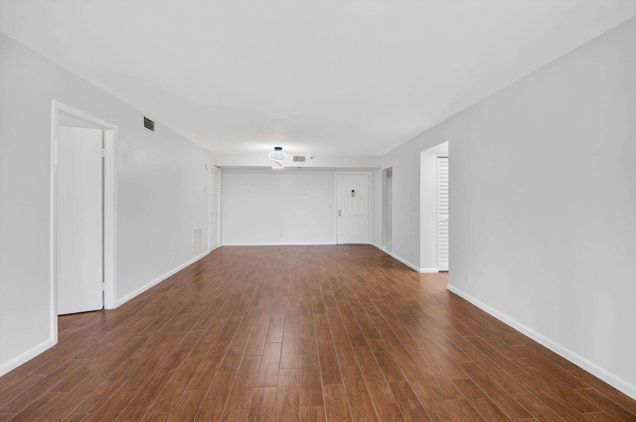 5260 Northwest 2nd Avenue, Unit 206 Boca Raton, FL 33487 - Photo 11 of 36 a view of empty room with wooden floor