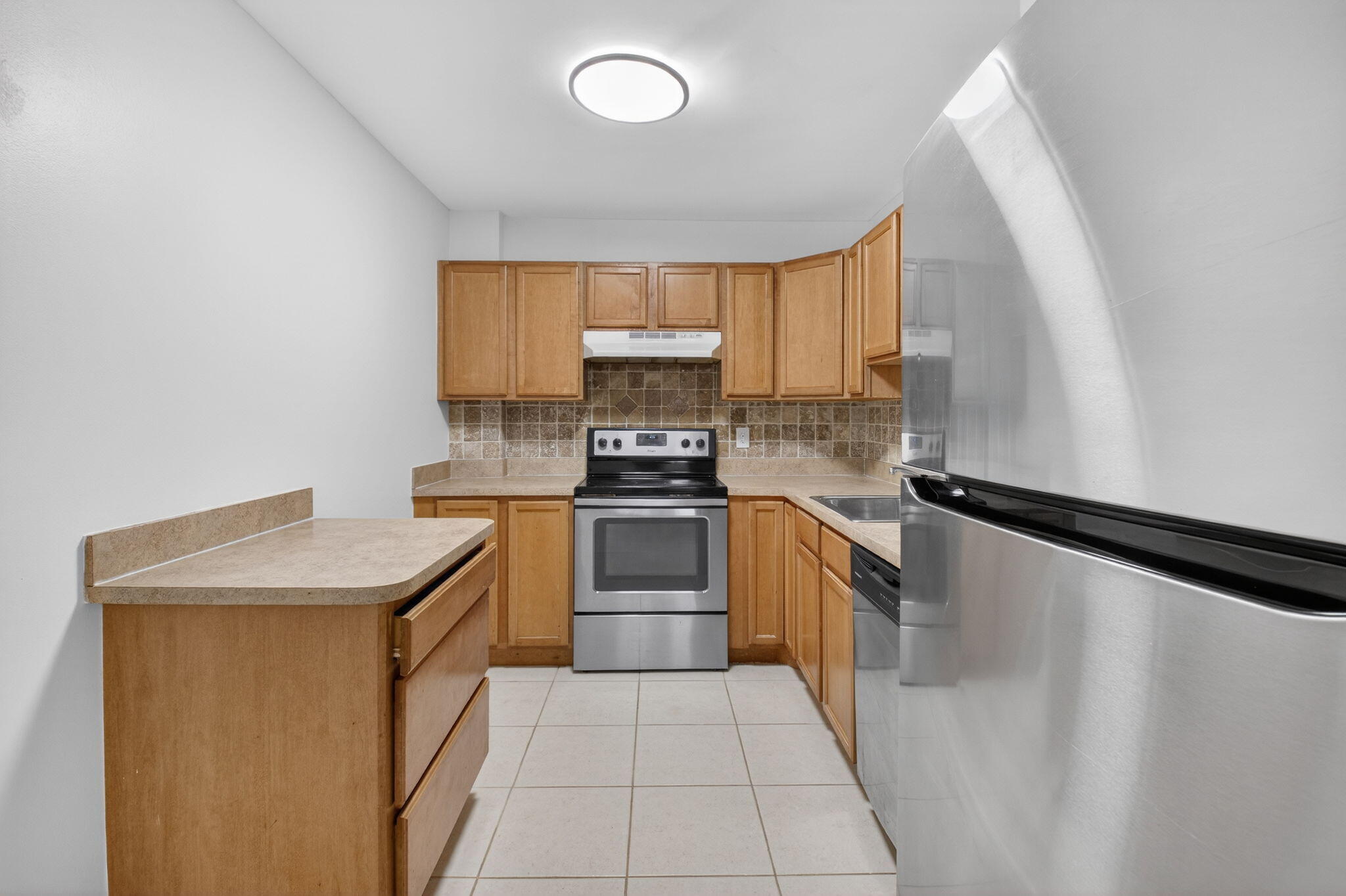 5260 Northwest 2nd Avenue, Unit 206 Boca Raton, FL 33487 - Photo 12 of 36 a kitchen with a refrigerator sink and stove top oven