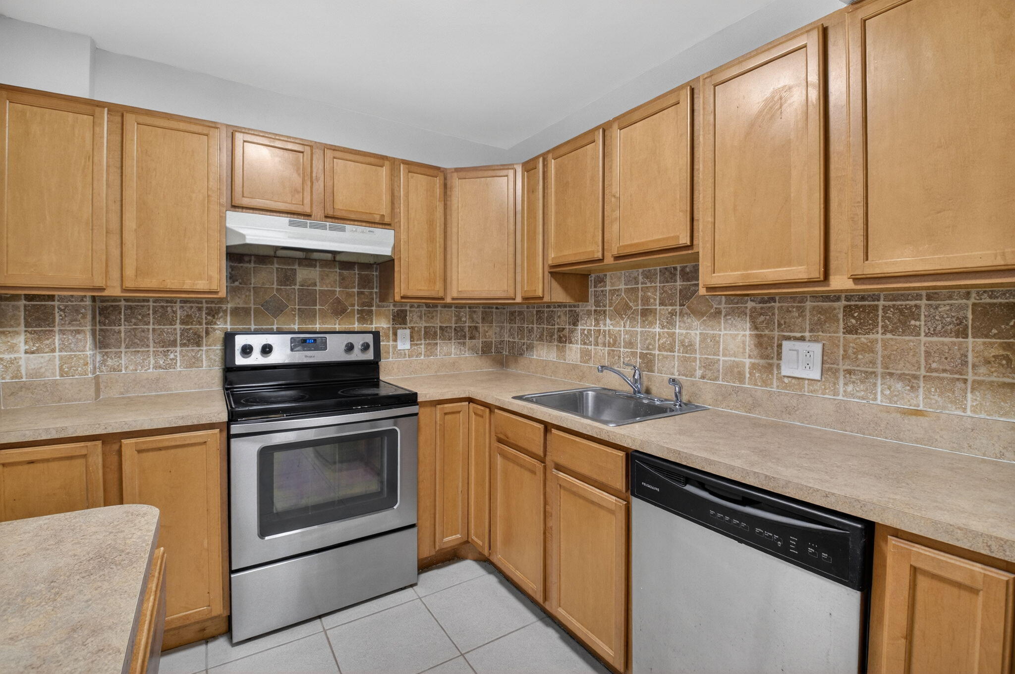 5260 Northwest 2nd Avenue, Unit 206 Boca Raton, FL 33487 - Photo 13 of 36 a kitchen with a sink stove and cabinets