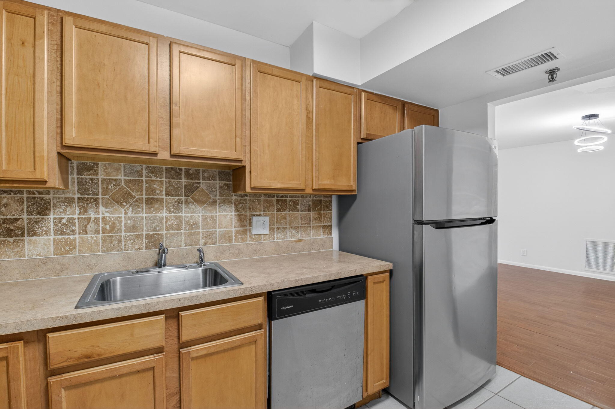 5260 Northwest 2nd Avenue, Unit 206 Boca Raton, FL 33487 - Photo 15 of 36 a kitchen with stainless steel appliances granite countertop a refrigerator sink and cabinets