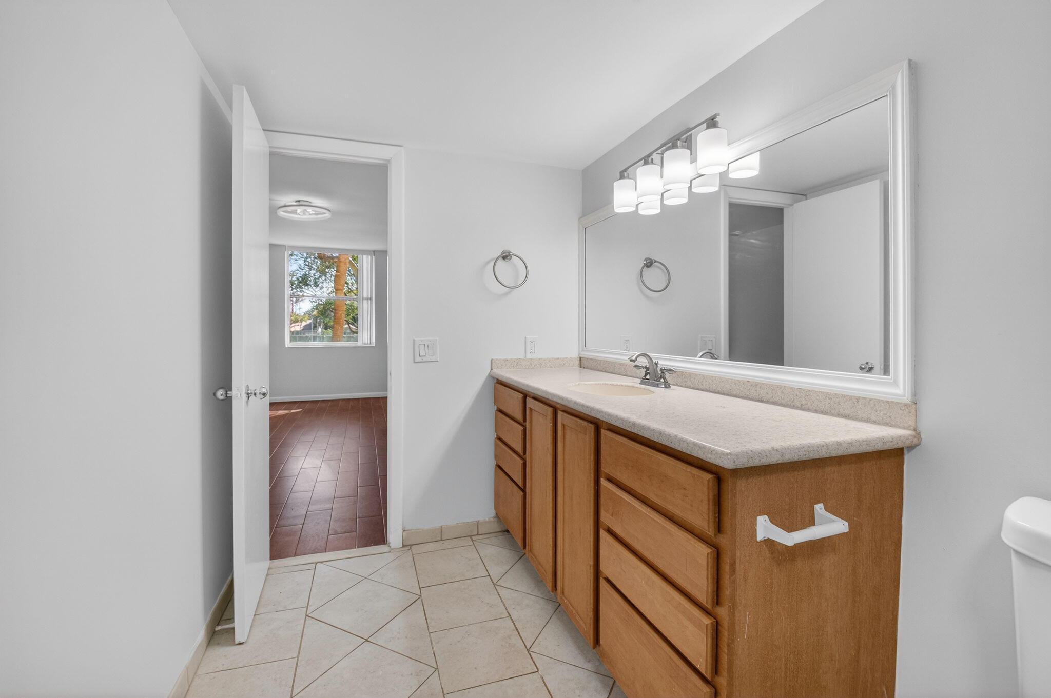 5260 Northwest 2nd Avenue, Unit 206 Boca Raton, FL 33487 - Photo 29 of 36 a bathroom with a sink and a mirror