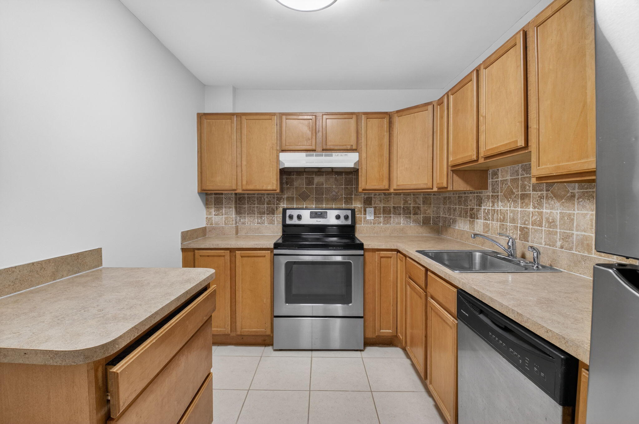 5260 Northwest 2nd Avenue, Unit 206 Boca Raton, FL 33487 - Photo 3 of 36 a kitchen with a sink stove and cabinets