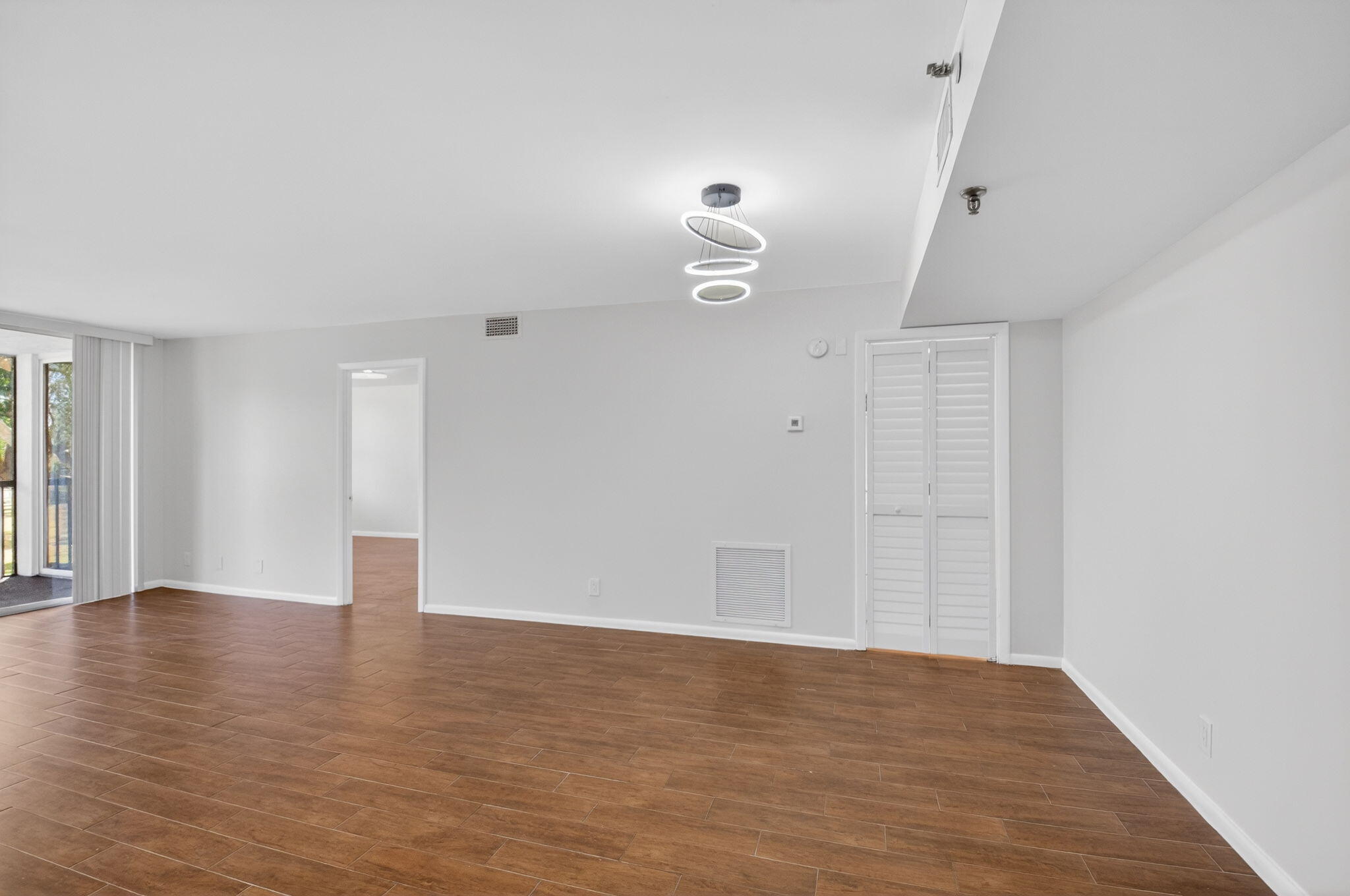 5260 Northwest 2nd Avenue, Unit 206 Boca Raton, FL 33487 - Photo 5 of 36 a view of an empty room with wooden floor