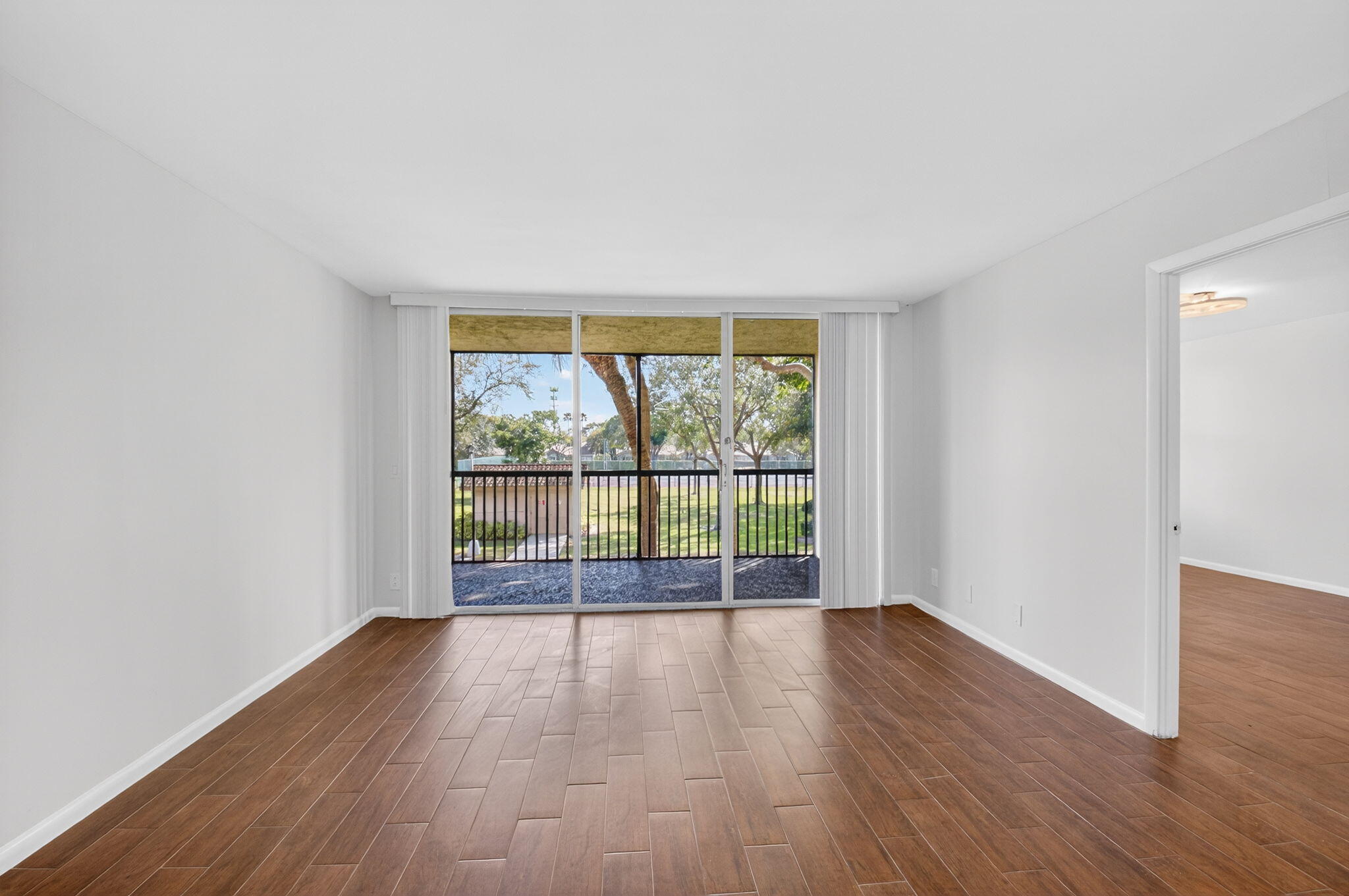 5260 Northwest 2nd Avenue, Unit 206 Boca Raton, FL 33487 - Photo 7 of 36 wooden floor in an empty room with a window