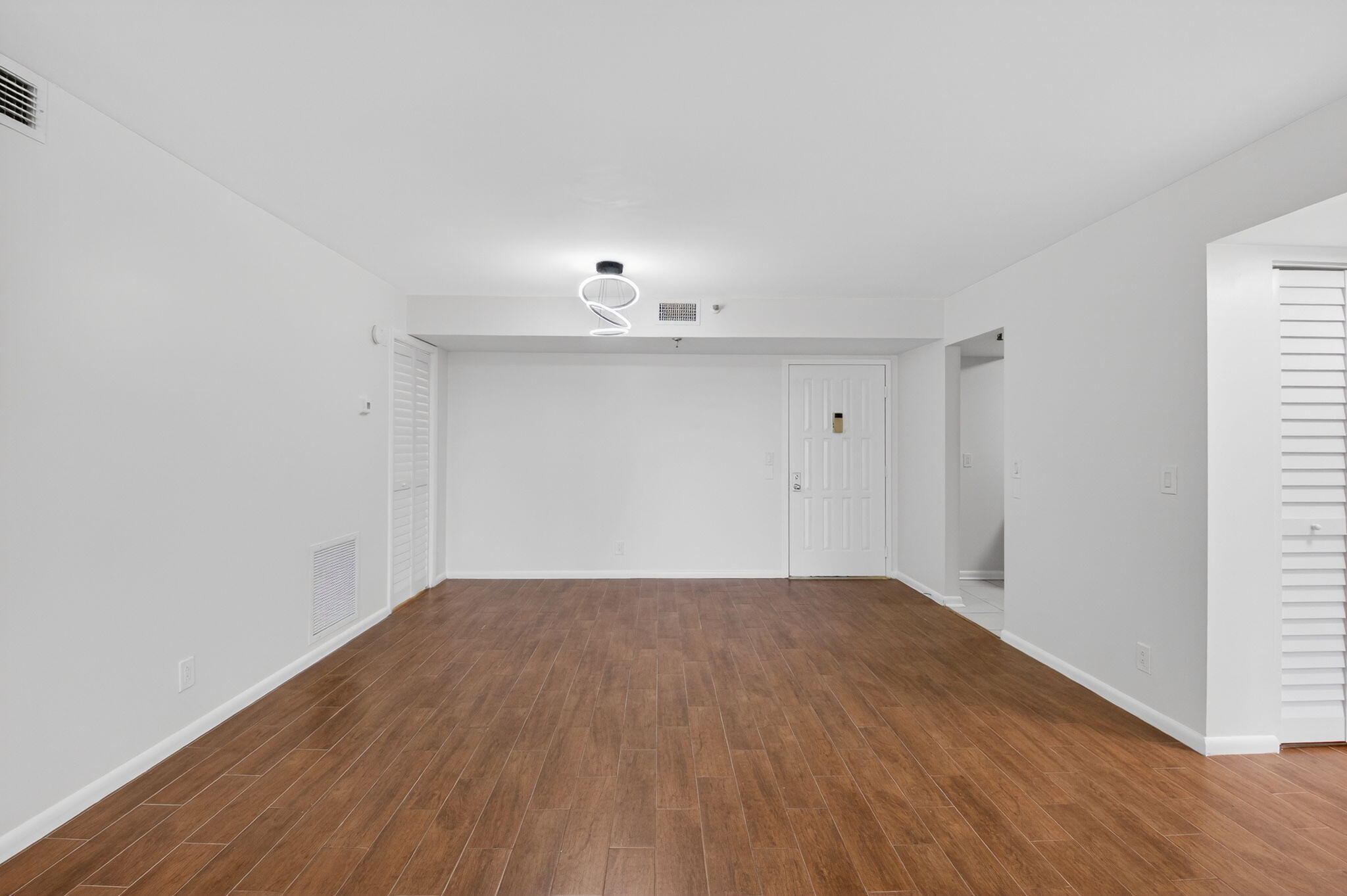 5260 Northwest 2nd Avenue, Unit 206 Boca Raton, FL 33487 - Photo 8 of 36 a view of an empty room with wooden floor