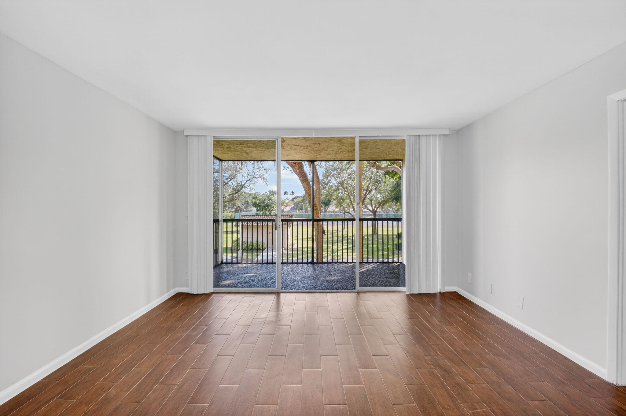 5260 Northwest 2nd Avenue, Unit 206 Boca Raton, FL 33487 - Photo 10 of 36 wooden floor in an empty room with a window