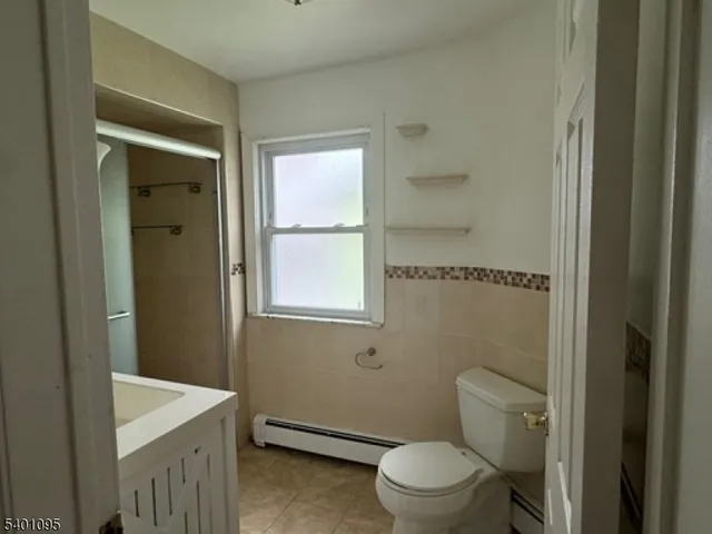 a bathroom with a granite countertop toilet a sink and a bathtub