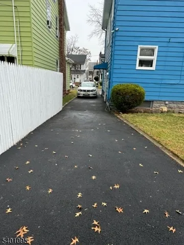 a backyard of a house with barbeque oven and barbeque oven