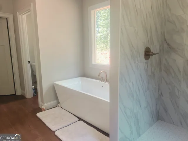 a bathroom with a bathtub and shower