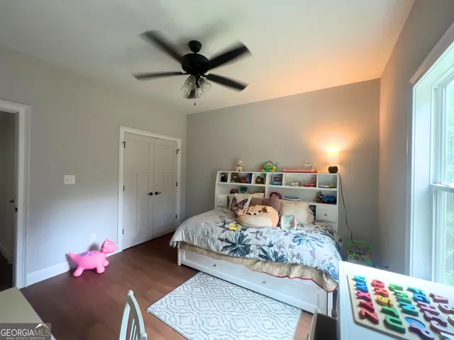 a bedroom with a bed and a dresser in it