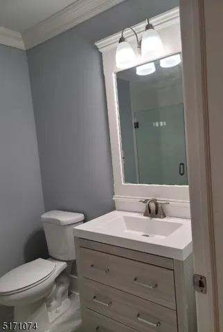 a bathroom with a sink and mirror with toilet