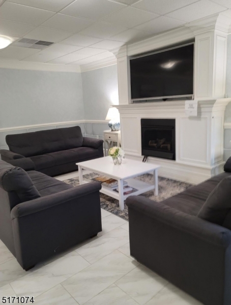 10 Lower Notch Road, Unit 8 Woodland Park, NJ 07424 - Photo 25 of 37 a living room with furniture and a flat screen tv