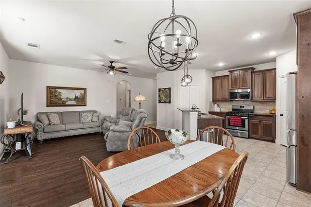 a view of a dining room with furniture wooden floor and chandelier