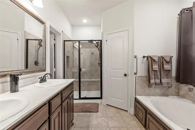 a bathroom with a tub sink and mirror